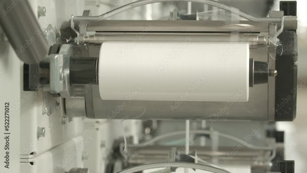 Closeup of polymer thread winding machine in action Closeup of polymer thread winding machine in action