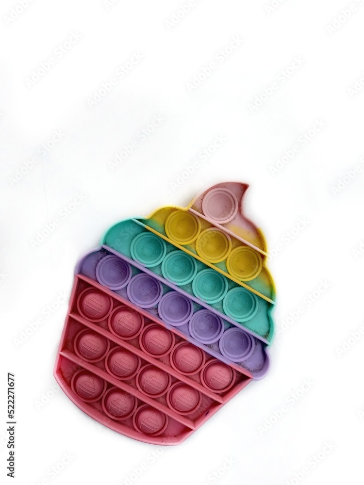 Colorful Pop it toy isolated on white background, multi color dusty silicone sensory toy has been used. Colorful Pop it toy isolated on white background, multi color dusty silicone sensory toy has been used.