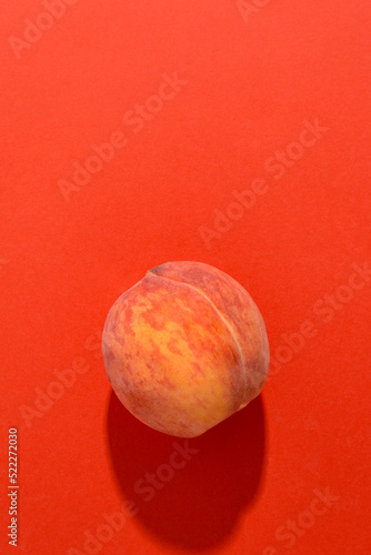 Peach on a bright red background