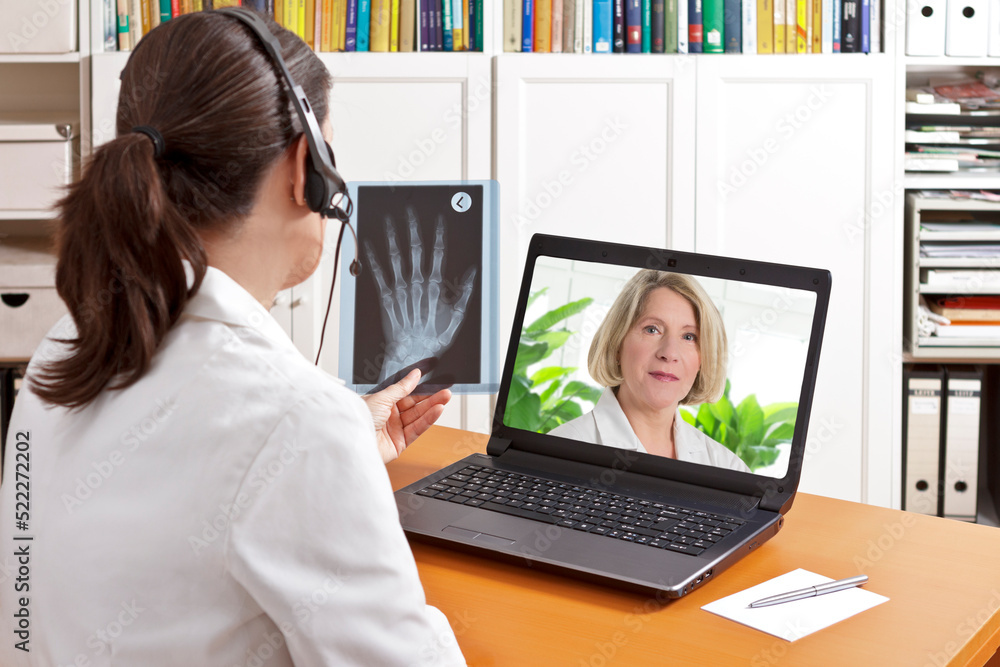 Telemedicine concept: two doctors or pharmacists during a medical video conference about x-ray results. Telemedicine concept: two doctors or pharmacists during a medical video conference about x-ray results.