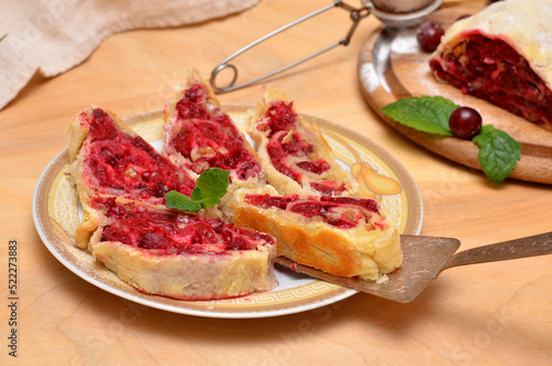 sliced ​​homemade Viennese strudel with cherry filling on a plate