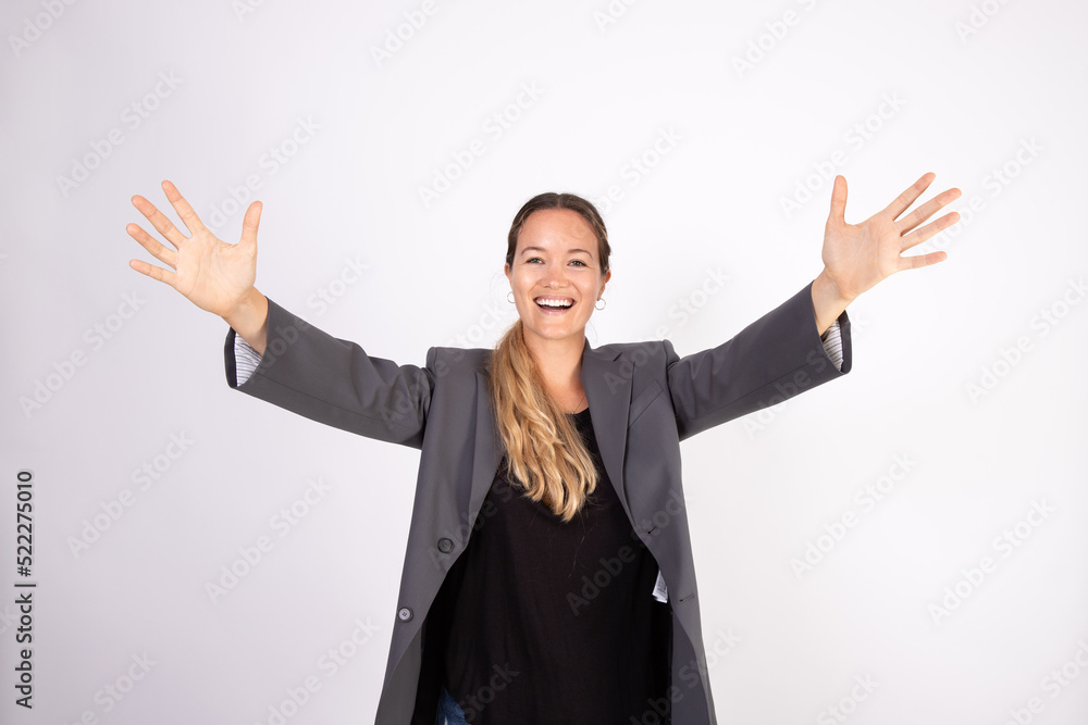 Portrait of happy young businesswoman stretching arms. Caucasian woman wearing gray suit coat and black blouse looking at camera in joy. Success and happiness concept Portrait of happy young businesswoman stretching arms. Caucasian woman wearing gray suit coat and black blouse looking at camera in joy. Success and happiness concept