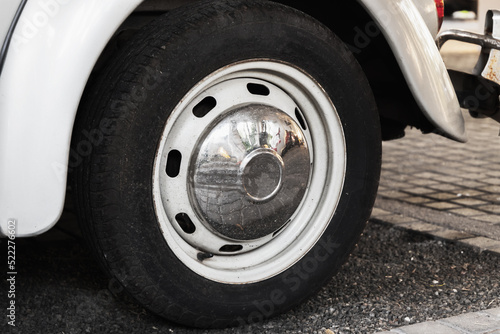 Vintage front car wheel with chromed cap, close up