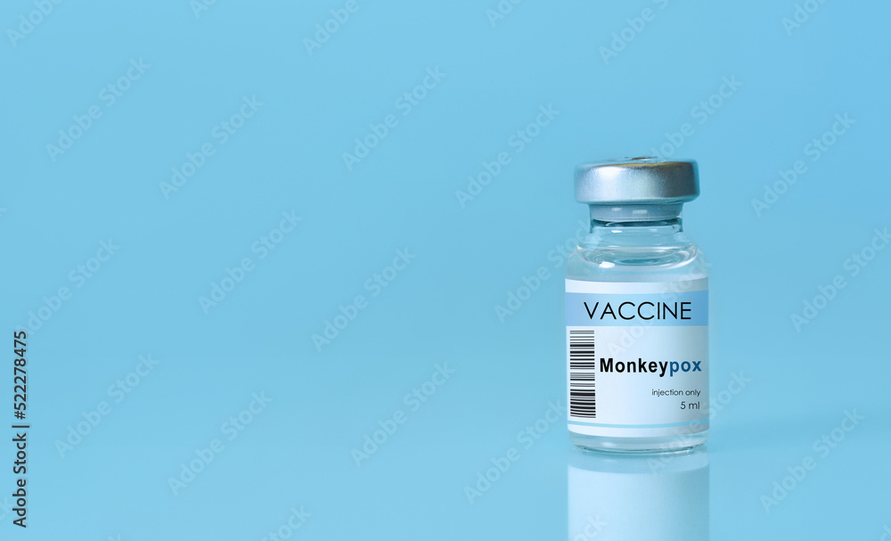 Vial with vaccine Monkeypox on a blue background.The concept of medicine, healthcare and science.Monkeypox is a viral zoonotic disease. Monkeys may harbor the virus and infect people.Copy space Vial with vaccine Monkeypox on a blue background.The concept of medicine, healthcare and science.Monkeypox is a viral zoonotic disease. Monkeys may harbor the virus and infect people.Copy space