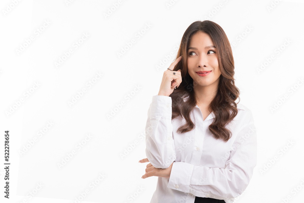 Asian woman with long hair, wearing a white shirt, is thinking and looking at the empty space. Asian woman with long hair, wearing a white shirt, is thinking and looking at the empty space.