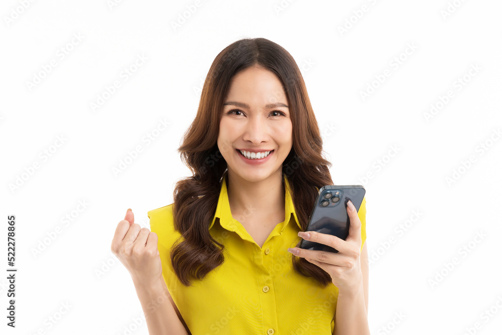 long hair asian woman wearing a green shirt, holding a smartphone, and excited isolated on white background. long hair asian woman wearing a green shirt, holding a smartphone, and excited isolated on white background.