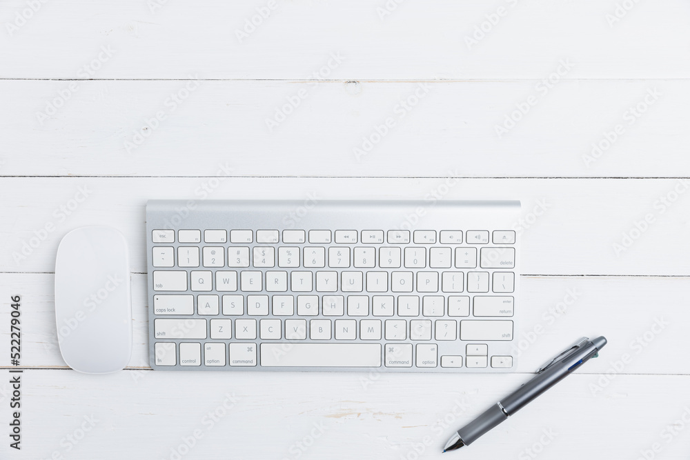 Top view table business of office with copy space. The desk in an office business with keyboard, mouse, a pen, on an old white wooden table. Business, technology concept.