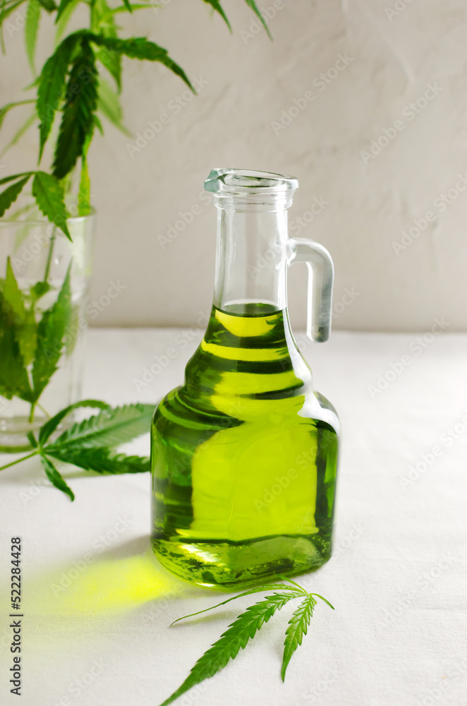 Cannabis CBD hemp oil in a glass bottle. The concept of Alternative Oil. Vertical orientation. Selective focus Cannabis CBD hemp oil in a glass bottle. The concept of Alternative Oil. Vertical orientation. Selective focus