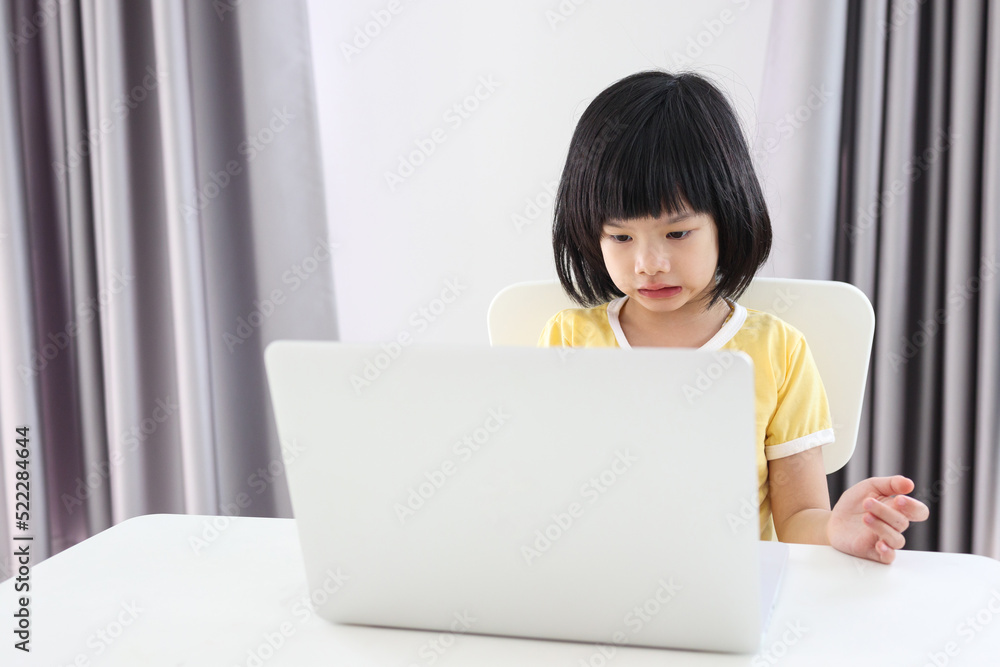 little asian girl student study online using laptop computer at home little asian girl student study online using laptop computer at home