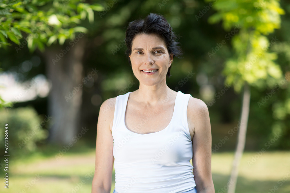Summer lifestyle portrait smile middle aged woman looking at camera relaxes outdoor. Enjoying the little things. spends time in nature in summer. Summer lifestyle portrait smile middle aged woman looking at camera relaxes outdoor. Enjoying the little things. spends time in nature in summer.