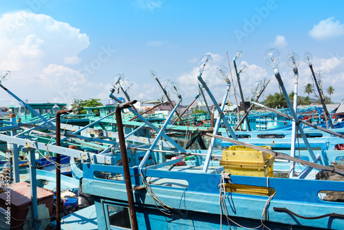 Row of large light mercury bulbs on a fishing boats for night squid fishing in Vietnam. © Вера Тихонова
