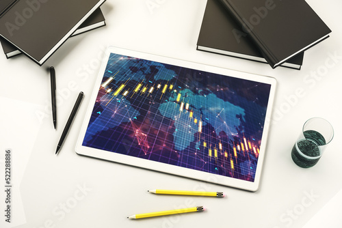 Top view of abstract financial diagram with world map on modern digital tablet monitor, banking and accounting concept. 3D Rendering