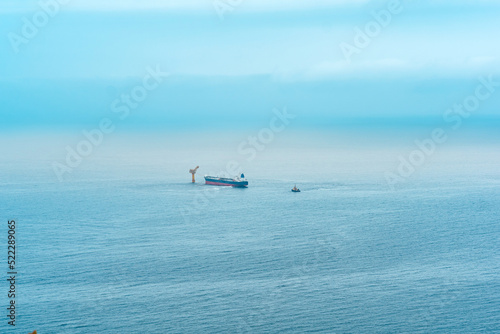 foggy seascape with a tanker near an oil terminal located far out to sea  top view