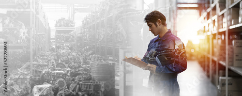 Asian male mechanic worker working at old motor automotive spare parts warehouse. Male engineer checking old engine, motor, machine at the garage industry factory. Double exposure