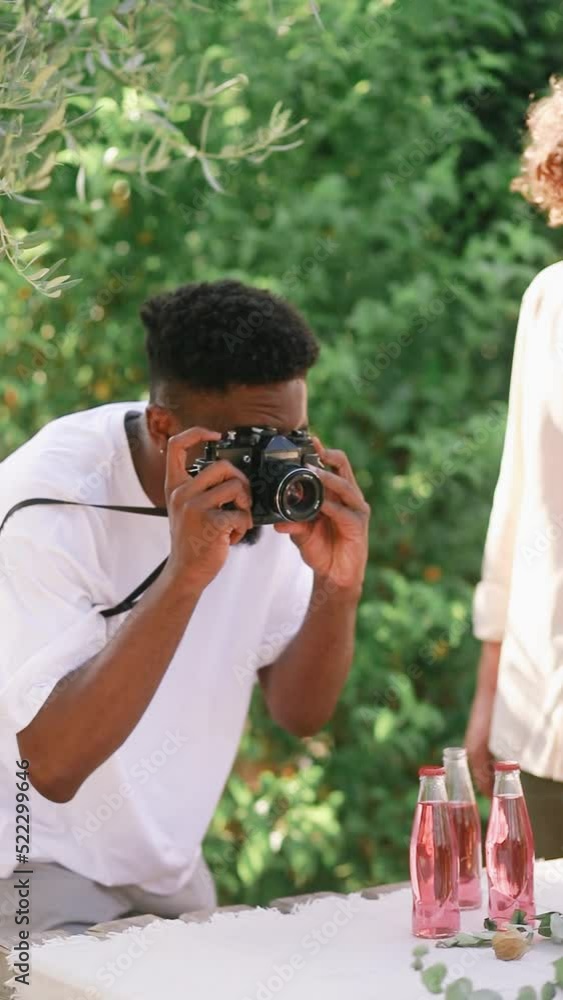 Black guy taking pictures of the summer dinner table setting