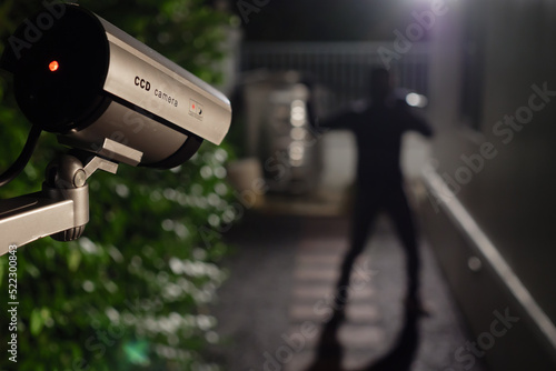 Fotografie, Obraz CCTV Surveillance camera capturing thief during breaking into house