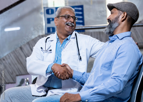 doctor and patient laughing during conversation  photo