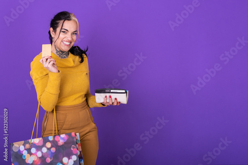 A women holding her wallet and shopping bag while showing a credit card. photo