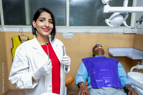 portrait of Female dentist holding equipment in hand in Clinic
