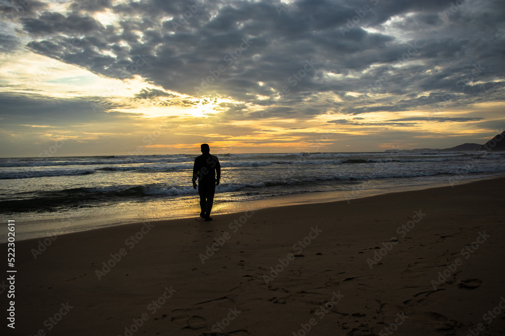Photo of a man alone on the beach in the afternoon, Aceh, Indonesia.