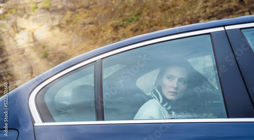 Woman is Commuting Home in a Backseat of a Taxi.