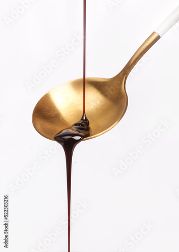 Chocolate dripping from the top on white background. photo