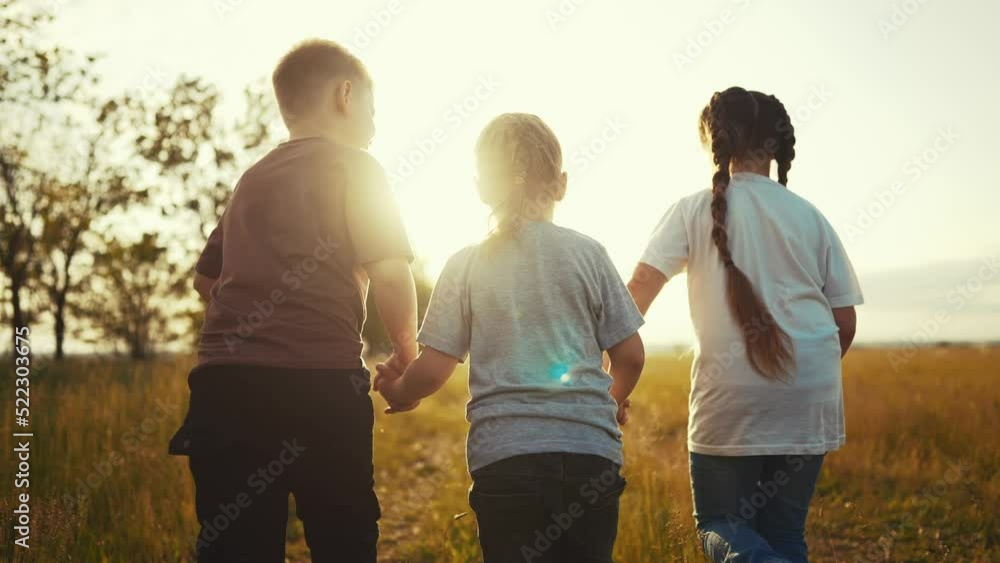children running in the park holding hands. happy family kindergarten kid dream concept. team of children hold hands run work as a team. children kid lifestyle run in the park children running in the park holding hands. happy family kindergarten kid dream concept. team of children hold hands run work as a team. children kid lifestyle run in the park