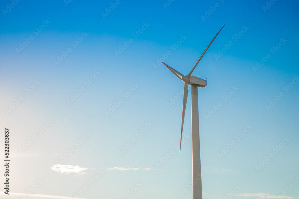 Windmills for electricity generation. Green energy concept. Background with copy space for text. Huge blades close up. Windmills for electricity generation. Green energy concept. Background with copy space for text. Huge blades close up.