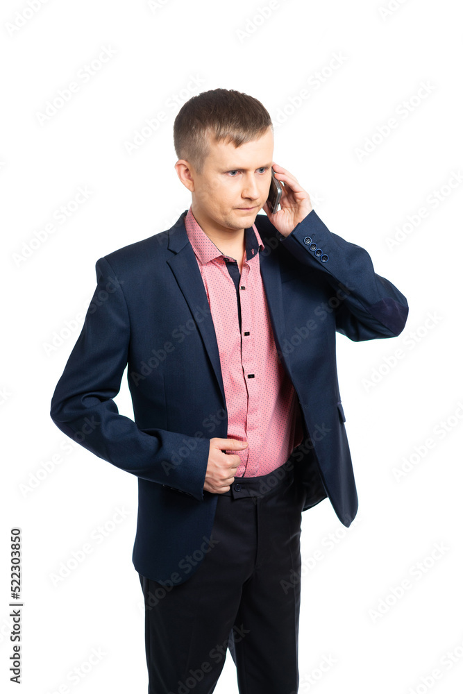 a man in a business suit is talking on the phone with a serious expression on his face. isolated a man in a business suit is talking on the phone with a serious expression on his face. isolated