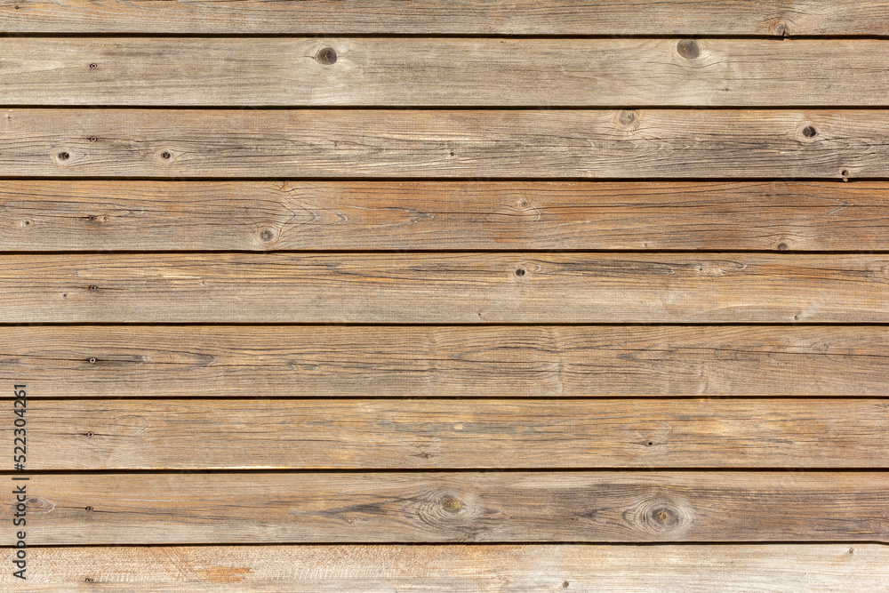 The texture of old gray-brown dark boards.Natural wooden background . The texture of old gray-brown dark boards.Natural wooden background .