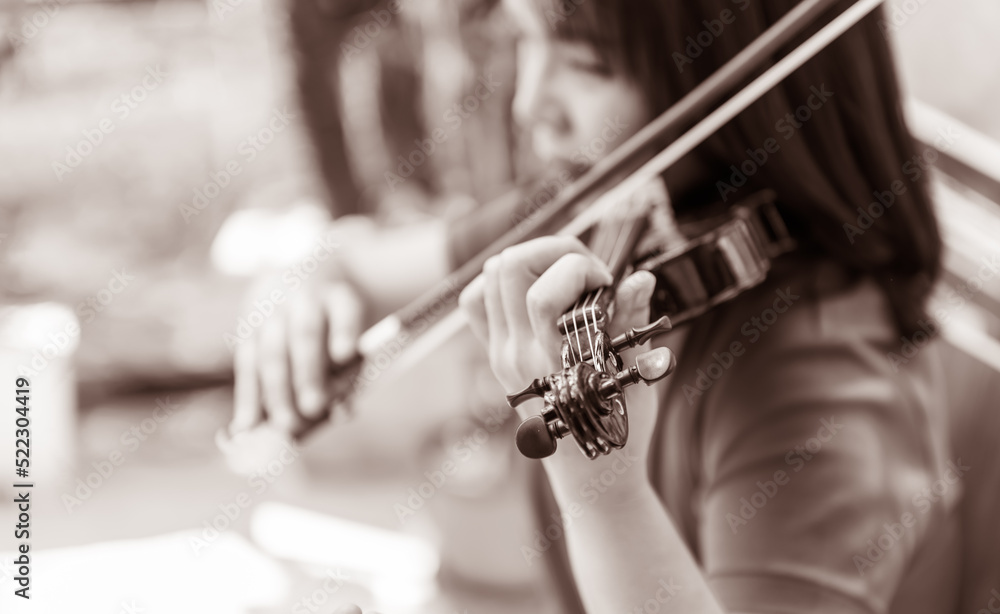 Blurred soft images of an Asian woman playing violin, to people and musician concept. Blurred soft images of an Asian woman playing violin, to people and musician concept.