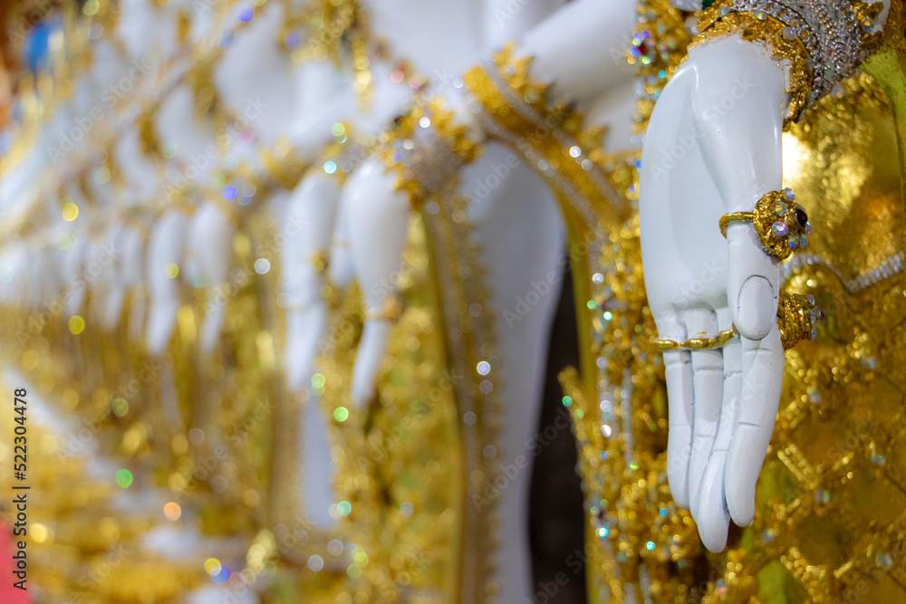 Fototapeta premium Close-up view of hand gesture of oriental statues of deities in a Buddhist temple