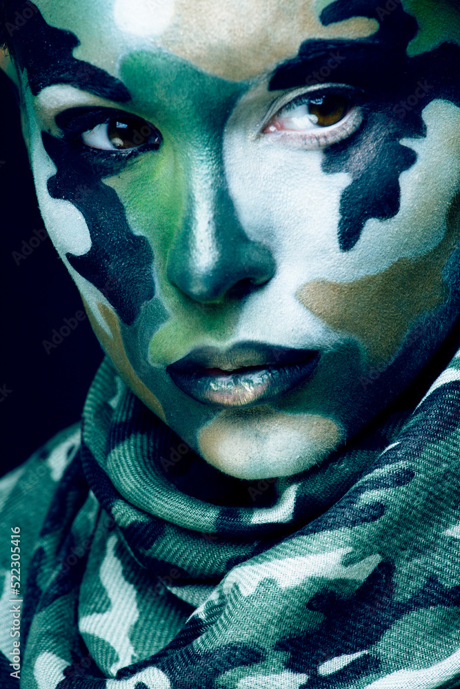 Beautiful young fashion woman with military style clothing and face paint make-up, khaki colors, halloween celebration Beautiful young fashion woman with military style clothing and face paint make-up, khaki colors, halloween celebration