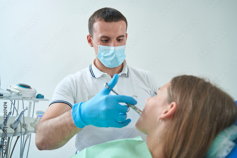 Pedodontist using local anesthesia before teeth treatment Pedodontist using local anesthesia before teeth treatment
