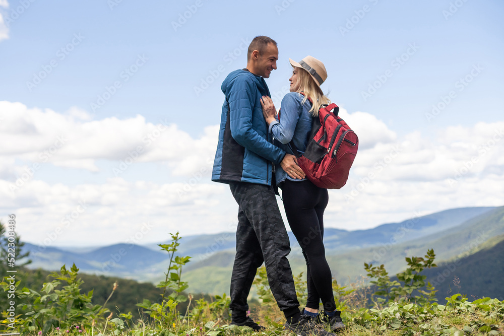 Portrait of beautiful young couple enjoying nature at mountain peak. Portrait of beautiful young couple enjoying nature at mountain peak.