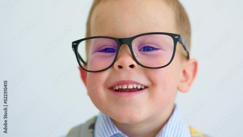 portrait happy caucasian baby boy child eyeglasses, child 4 years laughing smile, looking to camera. schoolboy pre elementary kindergarten age, wide smiling showing white teeth. back to school concept portrait happy caucasian baby boy child eyeglasses, child 4 years laughing smile, looking to camera. schoolboy pre elementary kindergarten age, wide smiling showing white teeth. back to school concept