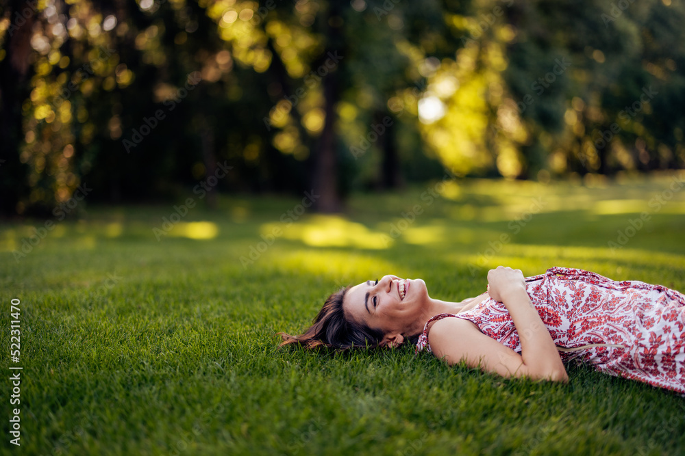 Girl laying on her back, smiling and looking at the sky. Girl laying on her back, smiling and looking at the sky.