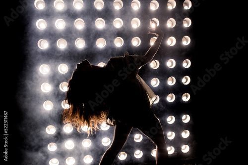 Sexy girl dance on front of spot light wall with smoke