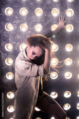 Sexy girl dance on front of spot light wall with smoke