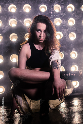 Sexy girl dance on front of spot light wall with smoke