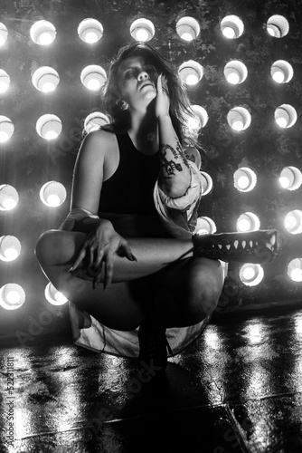 Sexy girl dance on front of spot light wall with smoke