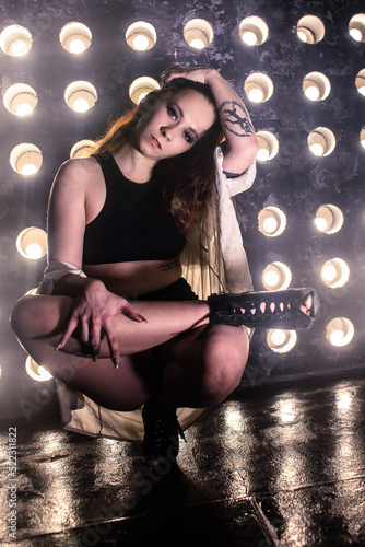 Sexy girl dance on front of spot light wall with smoke