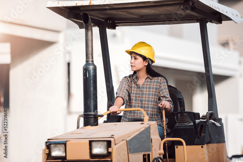 Asian woman construction engineer worker working at work site, women driving tractor at constructuon site.