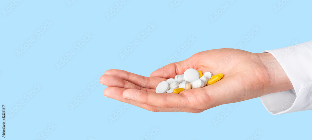 Pills in doctor hand. Pharmacy, pharmacology, medicine concept