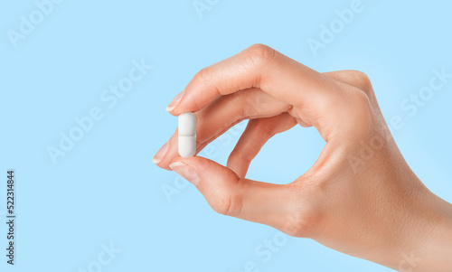 Pill of antibiotic in doctor hand. Pharmacy, pharmacology, medicine concept