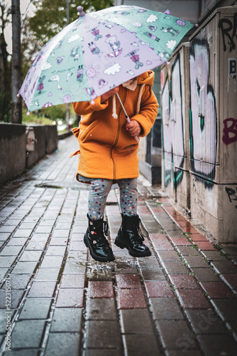 little girl with umbrella goes in the center from varna bulgaria 