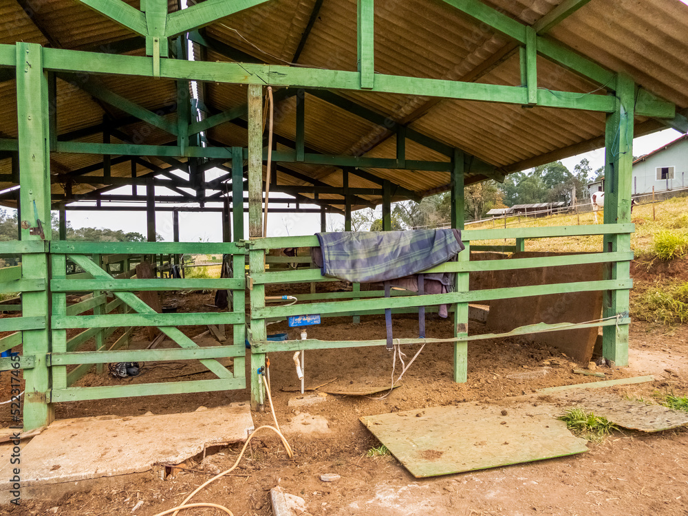 Barn at a farm. Green gate with saddle pad hanging on it. Barn at a farm. Green gate with saddle pad hanging on it.