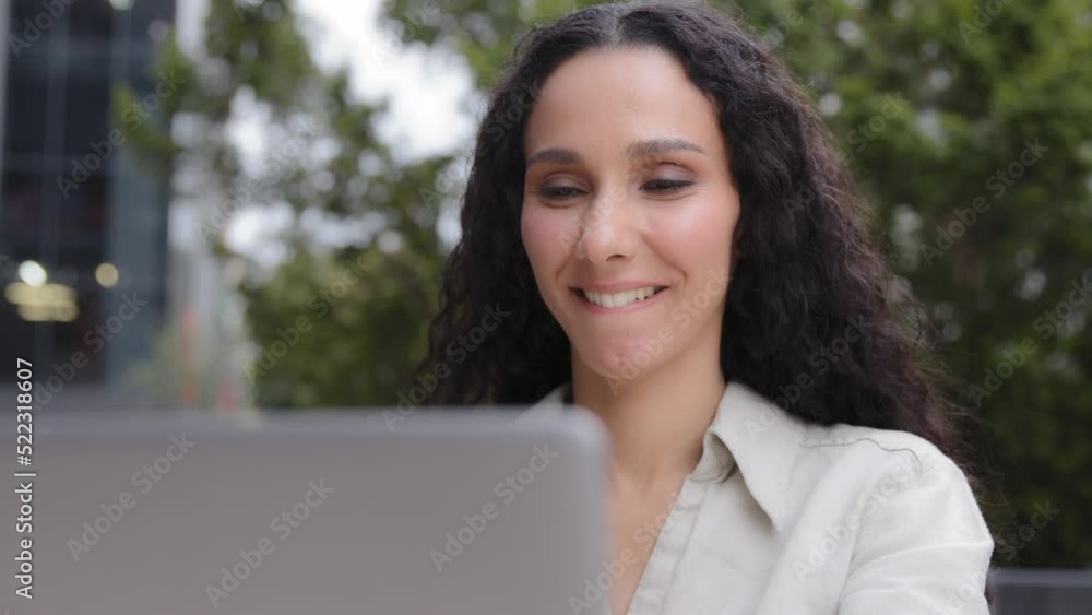Hispanic Caucasian happy smiling woman university student learning online using laptop computer outdoors, curly hair lady businesswoman smile enjoy remote working job app work with net sitting outside Hispanic Caucasian happy smiling woman university student learning online using laptop computer outdoors, curly hair lady businesswoman smile enjoy remote working job app work with net sitting outside
