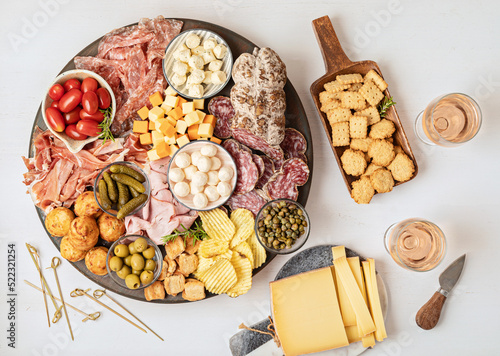 Appetizers table with different antipasti, charcuterie, snacks, cheese. Finger food for buffet party. Traditional french or italian entires. Top view photo