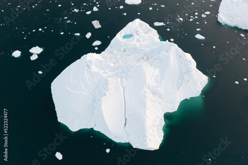 Climate change and global warming. Icebergs from a melting glacier in Ilulissat Glacier, Greenland. The icy landscape of the Arctic nature in the UNESCO world heritage site. Aerial view durin summer d